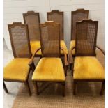 Six cane back dining chairs with upholstered seats and square tapering legs