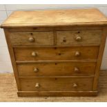 A pine two over three chest of drawers (H98cm W101cm D50cm)