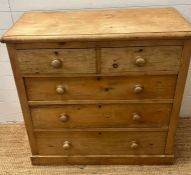 A pine two over three chest of drawers (H98cm W101cm D50cm)