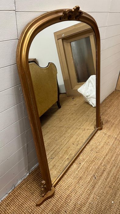 A large gilt frame arched over mantle mirror 127cm x 130cm