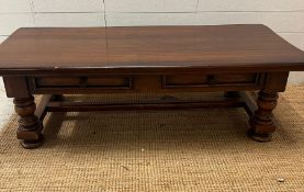 An oak coffee table on turned legs and drawers to centre (H42cm W139cm D63cm)