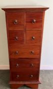 A hardwood tallboy consisting of four small drawers over three longer drawers (H112cm W46cm D43cm)