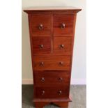 A hardwood tallboy consisting of four small drawers over three longer drawers (H112cm W46cm D43cm)