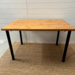 A pine topped table on black metal legs (H73cm W120cm)