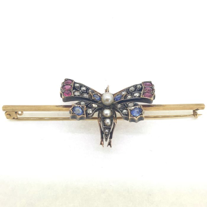 Victorian butterfly set with ruby, sapphire and rose cut diamonds in the wings. The body is