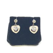 White metal diamond set heart drop earrings on a bezel set diamond stud with screw back posts and