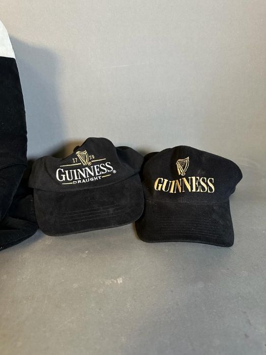 A collection of four Guinness baseball caps and a Guinness top hat - Image 4 of 4