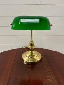 Brass bankers lamp with green glass shade.