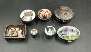 A selection of seven silver cat themed pill boxes.