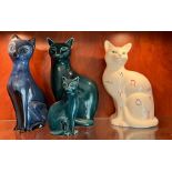 Three large seated china cats by Poole, Beswick and one other along with a smaller Poole pottery cat