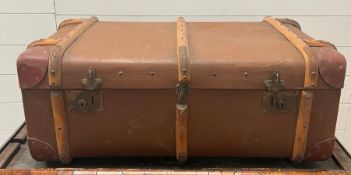 A vintage travel trunk with wooden and metal