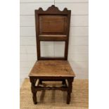 A 17th or 18th Century oak single chair on turned support and cross stretcher