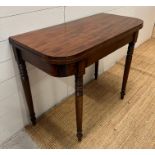 A mahogany card table on turned legs (H75cm W92cm D44cm)