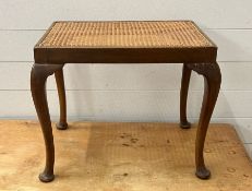 A mahogany framed and cane seat stool