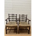 A pair of Georgian style mahogany open arm chairs