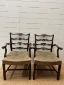 A pair of Georgian style mahogany open arm chairs