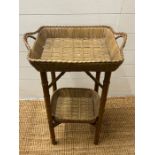 A bamboo style wicker side table with basket style top (H74cm W47cm)