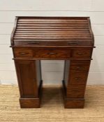 An oak small or child's pedestal roll top desk, six drawers and single cupboards and chair (H91cm