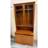 A Mid Century teak Remploy sideboard with two door cupboard under and glazed two door cabinet