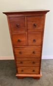 A hardwood tallboy with four short drawers and three long drawers (H112cm W46cm D43cm)