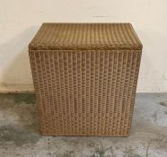 A gold painted wicker laundry basket