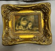 A miniature oil on canvas of two cats in a gilt heavily set frame