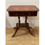 A regency style mahogany side table on four turned central pillars terminating on a square base