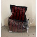 A red faux fur throw with charcoal backing and two matching cushions