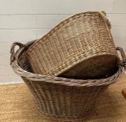 Two wicker handled laundry baskets