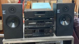 A Technics stereo system. Dual cassette, compact disc player and KEF K series speakers