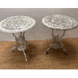 A pair of painted white metal bistro tables