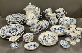 A Meissen blue onion pattern tea/breakfast service comprising of twelve cups, one candle holder, two