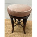 A regency style adjustable stool on turned legs