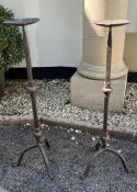 Two wrought iron candlesticks