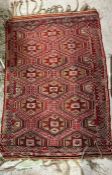 A red ground rug or wall hanging with yellow and browns 102cm x 146cm
