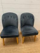 A pair of grey velvet side chairs by Made
