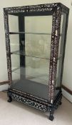 A hardwood, double side opening Chinese display cabinet with mother of pearl inlay and three glass