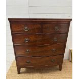 A two over three mahogany bow fronted chest of drawers, brass drop handles on splayed legs.(H