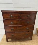 A two over three mahogany bow fronted chest of drawers, brass drop handles on splayed legs.(H