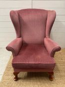 A Parker Knoll wing back arm chair upholstered in burnt pink