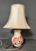 A Moorcroft lamp base in the magnolia pattern.