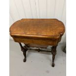 A Victorian Burr Walnut Games Table. The table top opens to reveal Chess, back gammon and cribbage