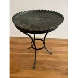 A wrought iron based side table with ornate metal top (H 52cm x D 36cm)