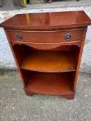 A side cabinet with drawer to centre and ring handles