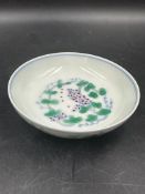 A small Chinese dish. White ground with a floral motif