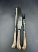 A pistol grip silver carving set with sharpener by C W Fletcher & Son Ltd, hallmarked for London