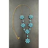 A silver gilt turquoise set flower cluster necklace on a 9 carat gold chain.