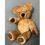 A vintage Harrods teddy bear with growler