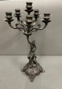 An Art Nouveau style candelabra with six candle holders on scrolling arms