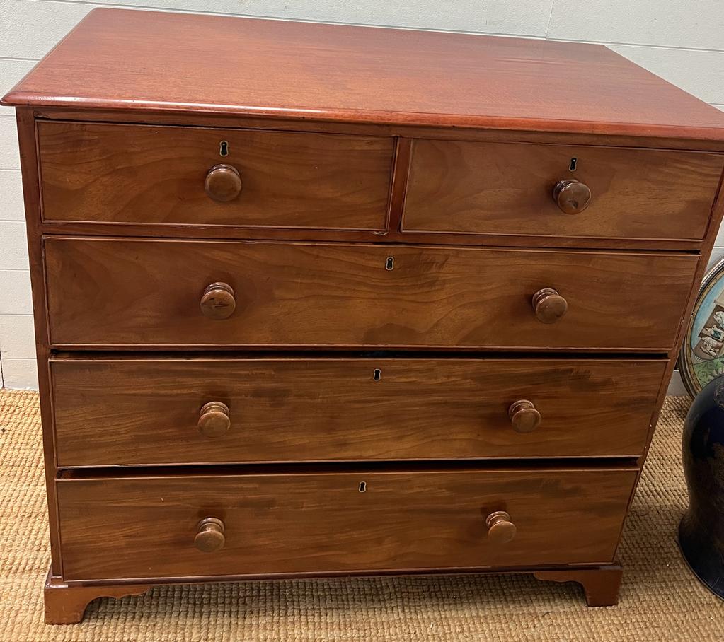 A two over three chest of drawers with bun handles and bracket feet ( 105cm x 54D x 97H)